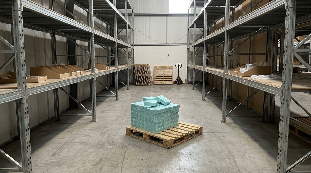 A nearly empty warehouse with the remaining ReHears boxes on one pallet